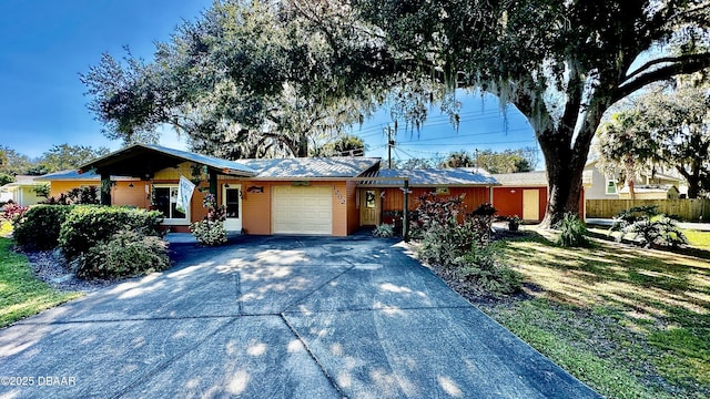 ranch-style home featuring concrete driveway, fence, and a garage