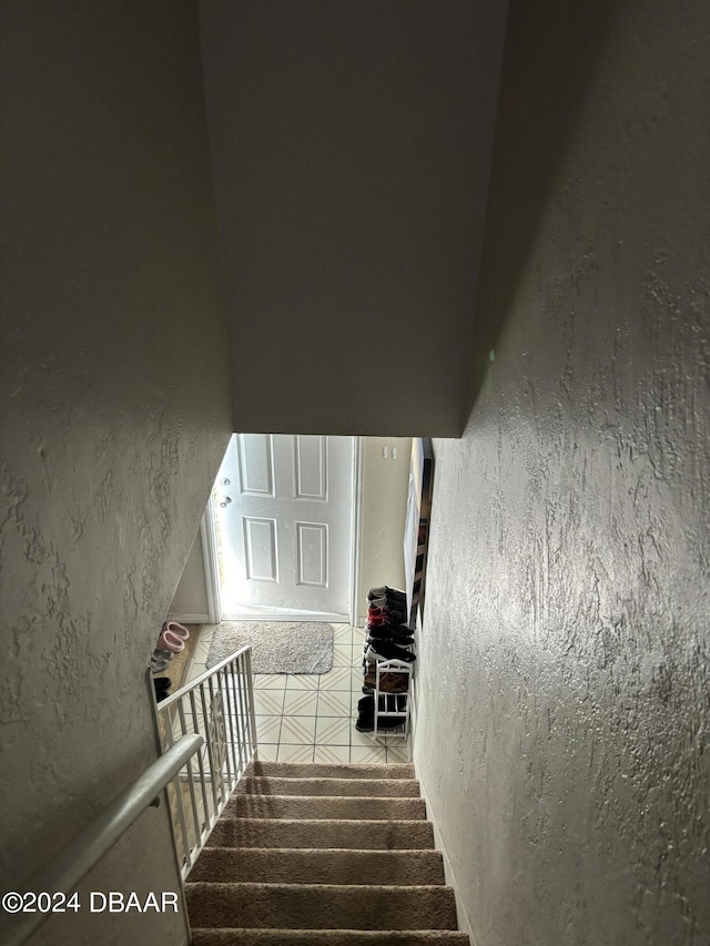 staircase with tile patterned floors