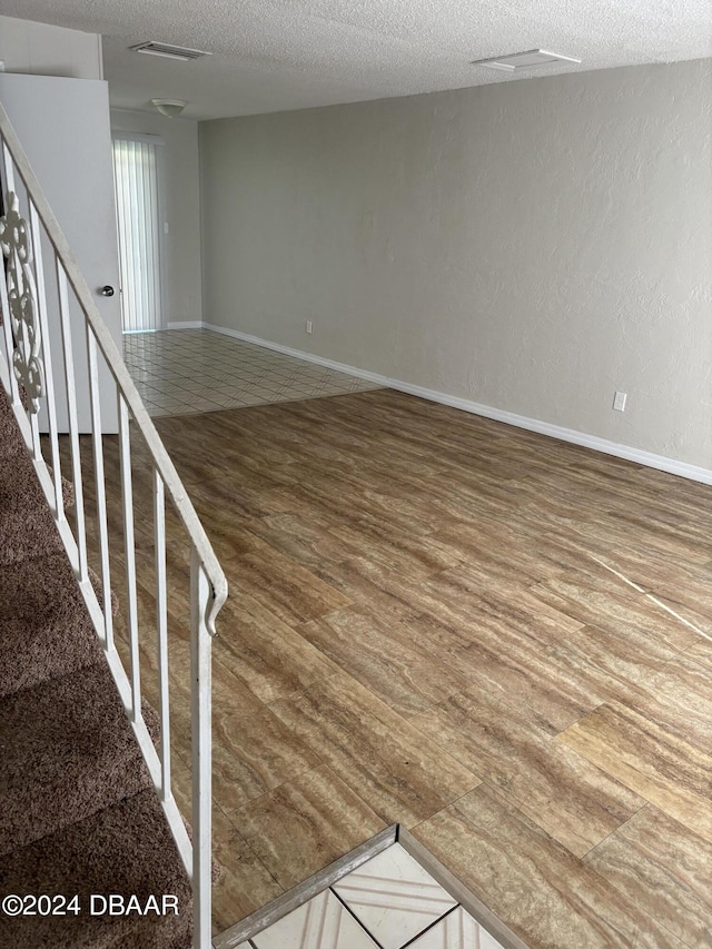 interior space with hardwood / wood-style floors and a textured ceiling