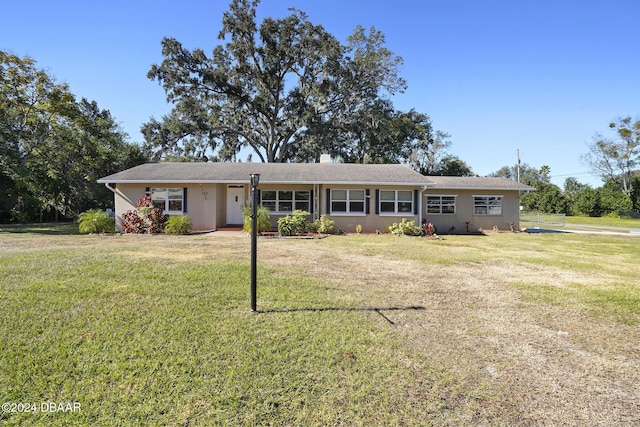 ranch-style home with a front lawn