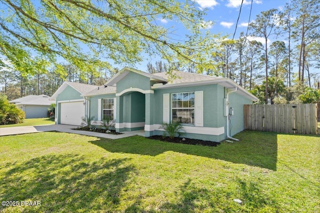 view of front of home with fence, an attached garage, stucco siding, concrete driveway, and a front lawn