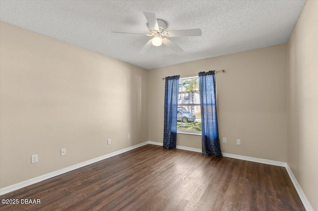 unfurnished room featuring a textured ceiling, dark wood-type flooring, baseboards, and ceiling fan