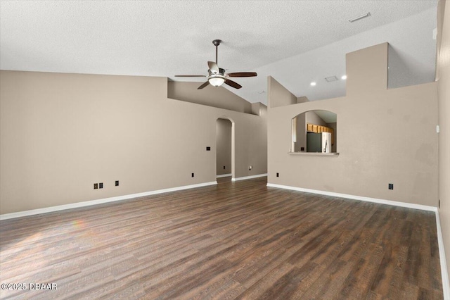 unfurnished living room featuring wood finished floors, baseboards, visible vents, lofted ceiling, and ceiling fan