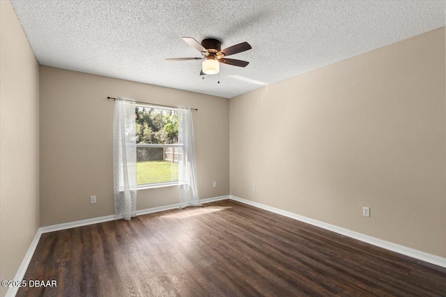 empty room featuring a textured ceiling, baseboards, ceiling fan, and wood finished floors