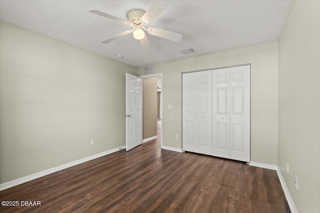 unfurnished bedroom with wood finished floors, visible vents, and baseboards