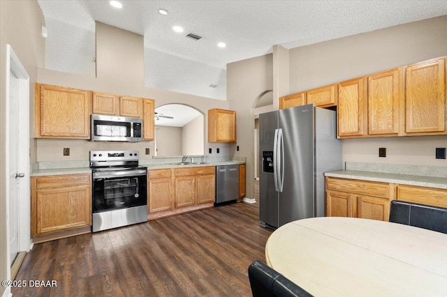 kitchen with visible vents, stainless steel appliances, light countertops, and vaulted ceiling