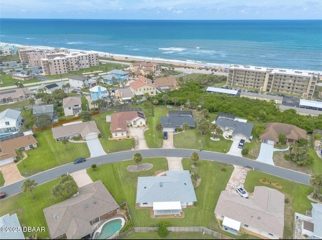 aerial view with a water view and a beach view