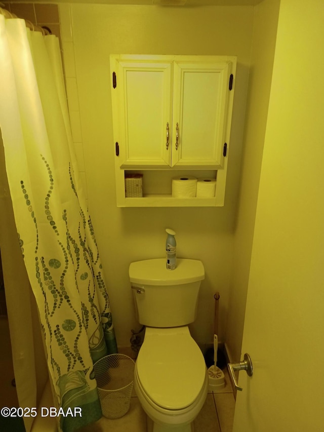 2043 S Atlantic Ave Unit 311, Daytona Beach, FL 32118 - bathroom with toilet, tile patterned flooring, and a shower with shower curtain