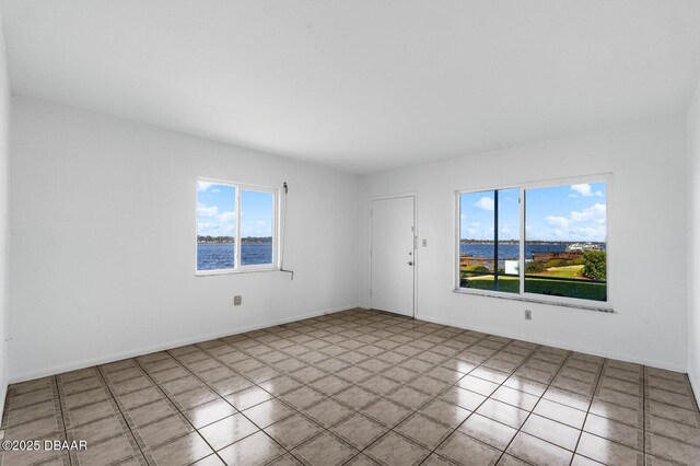 3009 N Halifax Ave Unit 9, Daytona Beach, FL 32118 - tiled spare room featuring a healthy amount of sunlight
