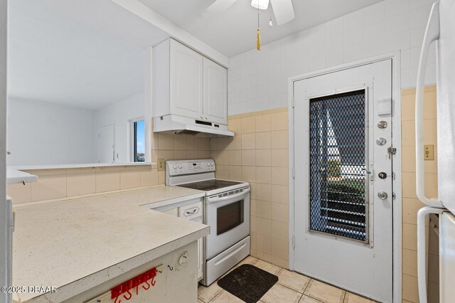 3009 N Halifax Ave Unit 9, Daytona Beach, FL 32118 - kitchen with white electric range oven, light countertops, white cabinetry, light tile patterned floors, and under cabinet range hood
