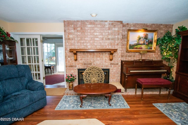 living room with a fireplace and wood finished floors