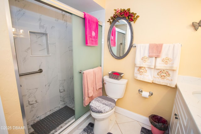 bathroom featuring tile patterned flooring, toilet, vanity, and a marble finish shower