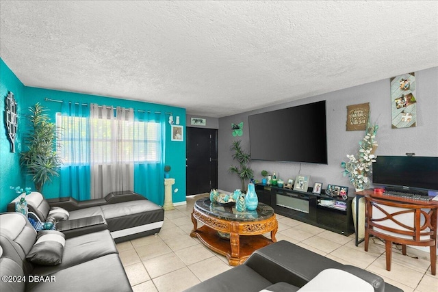 living room with a textured ceiling and light tile patterned flooring