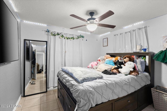 tiled bedroom featuring a textured ceiling and ceiling fan