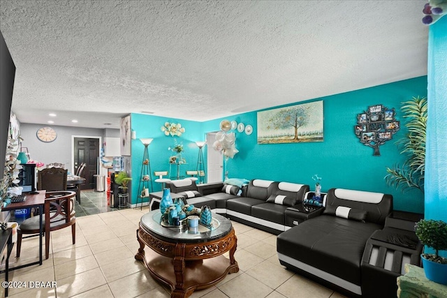 living room with a textured ceiling and light tile patterned floors