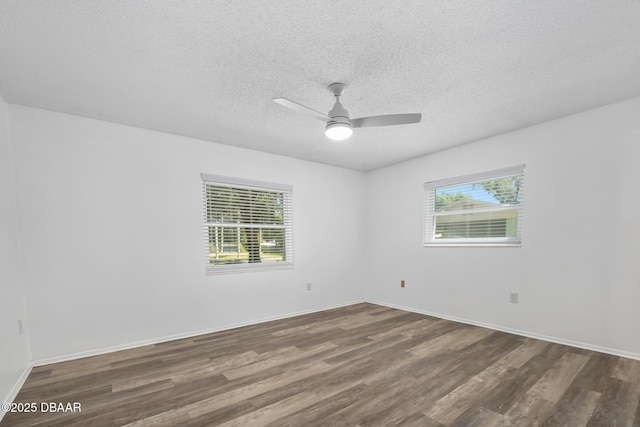 spare room with a textured ceiling, baseboards, a ceiling fan, and wood finished floors