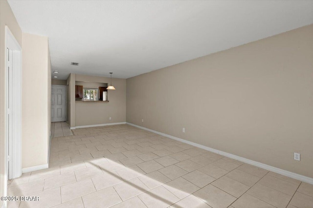 unfurnished room featuring light tile patterned flooring