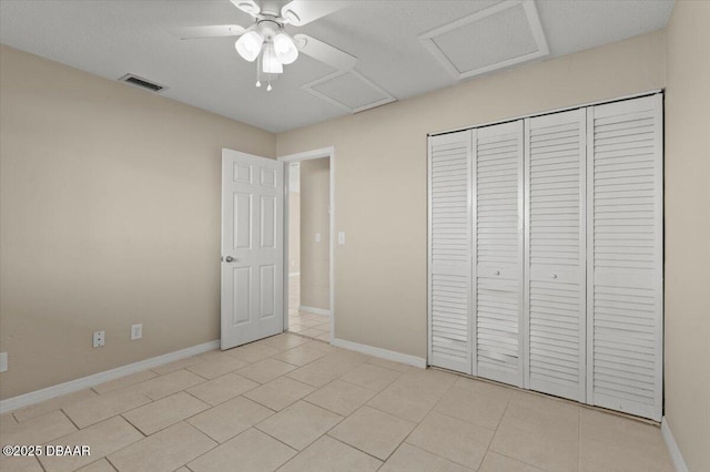 unfurnished bedroom featuring a closet, ceiling fan, and light tile patterned flooring