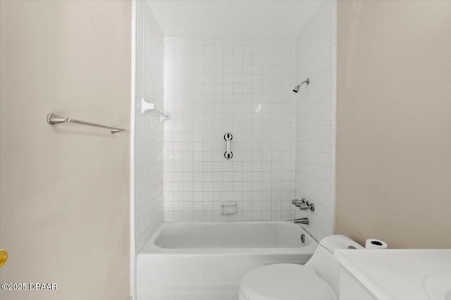 full bathroom with vanity, tiled shower / bath, and toilet