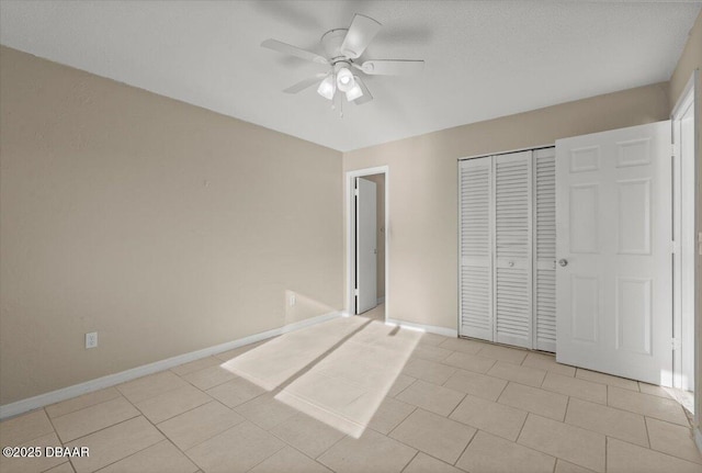 unfurnished bedroom featuring light tile patterned flooring, ceiling fan, and a closet