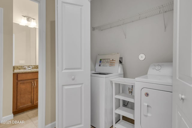 clothes washing area featuring independent washer and dryer, sink, and light tile patterned floors