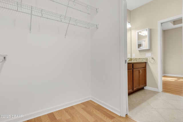 spacious closet featuring light wood-type flooring