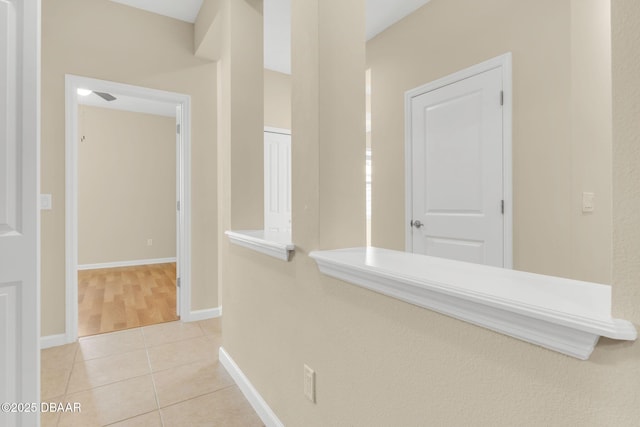 hallway with light tile patterned floors