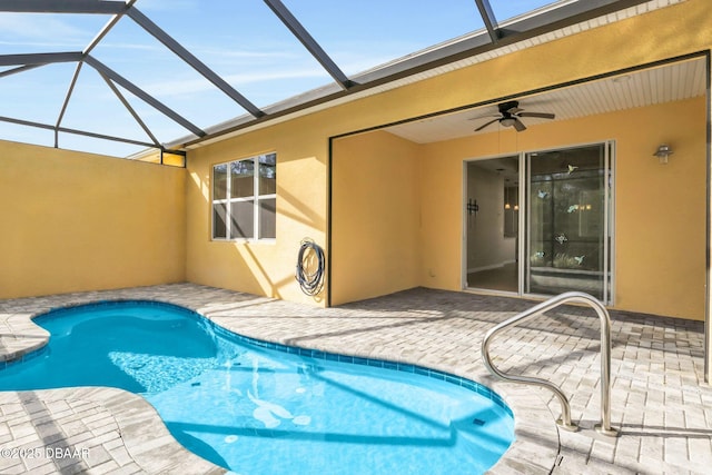 view of swimming pool with a patio, a lanai, and ceiling fan