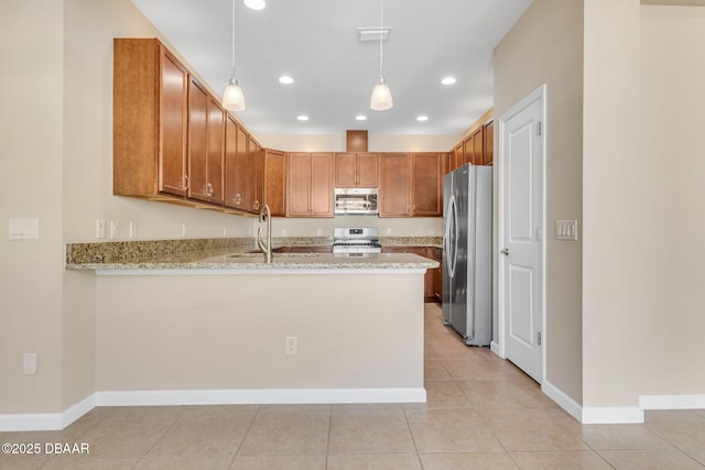 kitchen with pendant lighting, sink, kitchen peninsula, stainless steel appliances, and light stone countertops