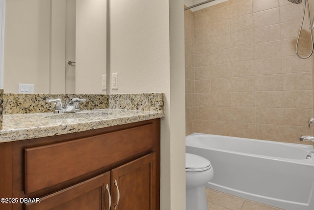 full bathroom with tile patterned flooring, vanity, tiled shower / bath combo, and toilet