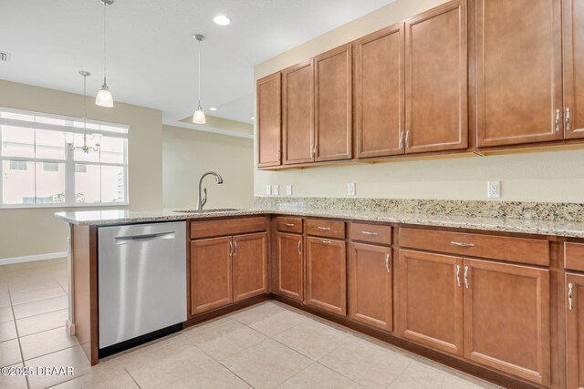 kitchen featuring decorative light fixtures, dishwasher, sink, light tile patterned floors, and light stone countertops