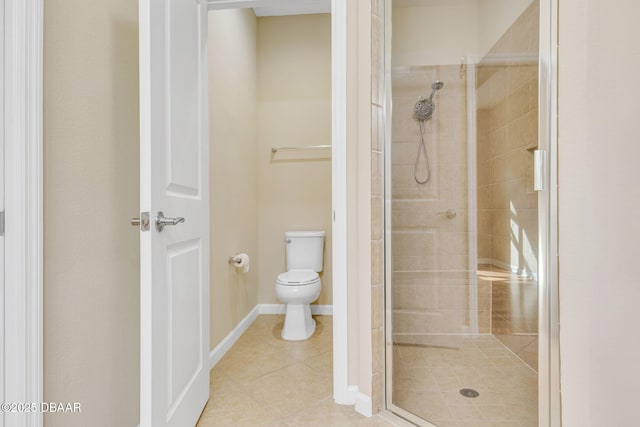 bathroom with tile patterned floors, toilet, and an enclosed shower