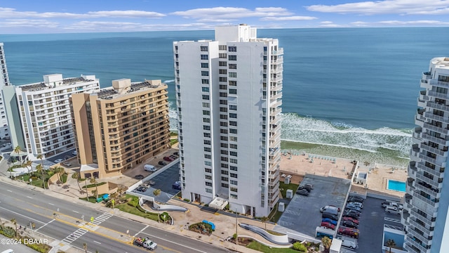 birds eye view of property with a water view and a view of the beach