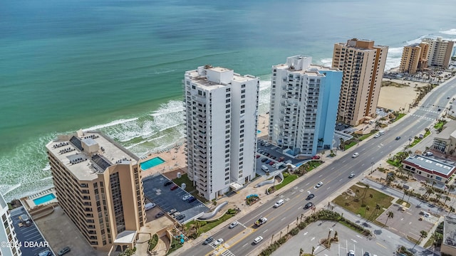 birds eye view of property featuring a water view and a beach view