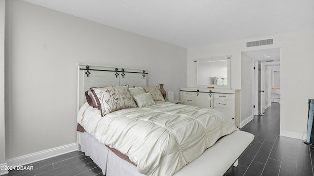 bedroom with dark hardwood / wood-style floors