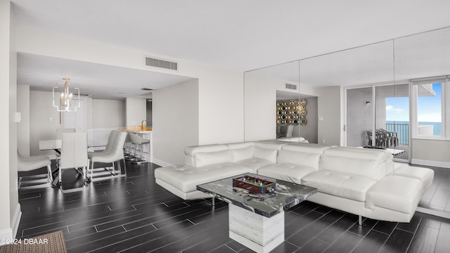 living room featuring dark hardwood / wood-style flooring and a water view