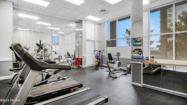 gym with a paneled ceiling