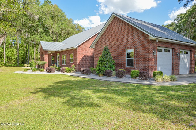 view of side of home featuring a garage and a yard