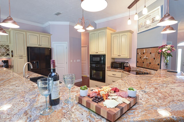 kitchen with black appliances, light stone counters, ornamental molding, hanging light fixtures, and an inviting chandelier