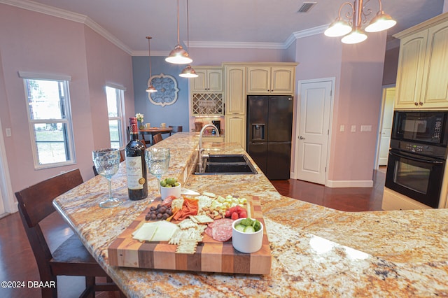 kitchen featuring cream cabinetry, sink, black appliances, and light stone counters