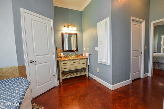 bathroom with ornamental molding, concrete flooring, and vanity