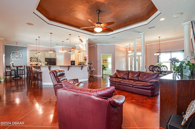 living room featuring ornate columns, ceiling fan with notable chandelier, crown molding, and a raised ceiling