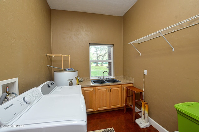 laundry room featuring cabinets, water heater, sink, and washer and clothes dryer