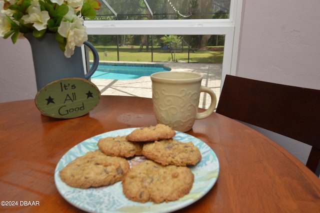 view of swimming pool featuring a patio, a lawn, and a lanai