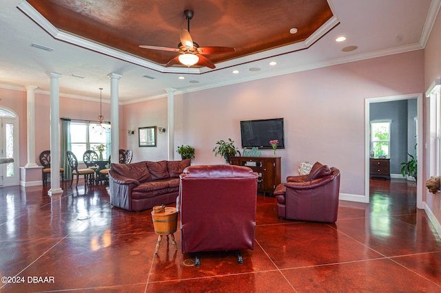 living room with ceiling fan, ornate columns, crown molding, and a raised ceiling