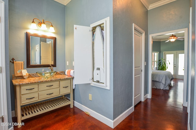 bathroom with ornamental molding, hardwood / wood-style floors, vanity, and ceiling fan