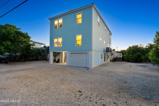 exterior space featuring central air condition unit and a garage