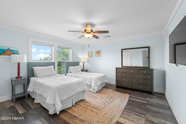 bedroom featuring ornamental molding, dark hardwood / wood-style flooring, and ceiling fan