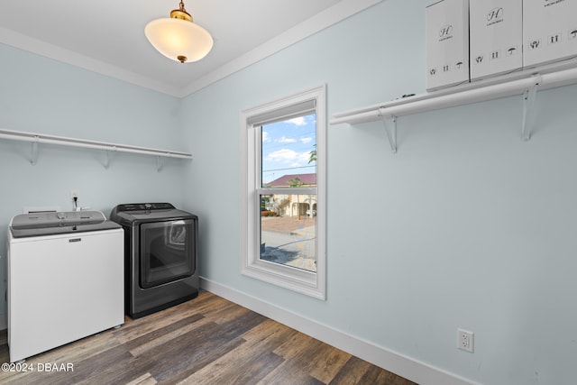 clothes washing area with dark hardwood / wood-style flooring, separate washer and dryer, and crown molding