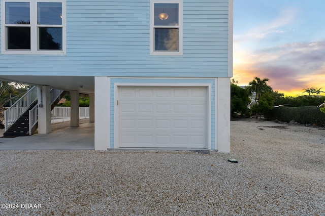 view of garage at dusk